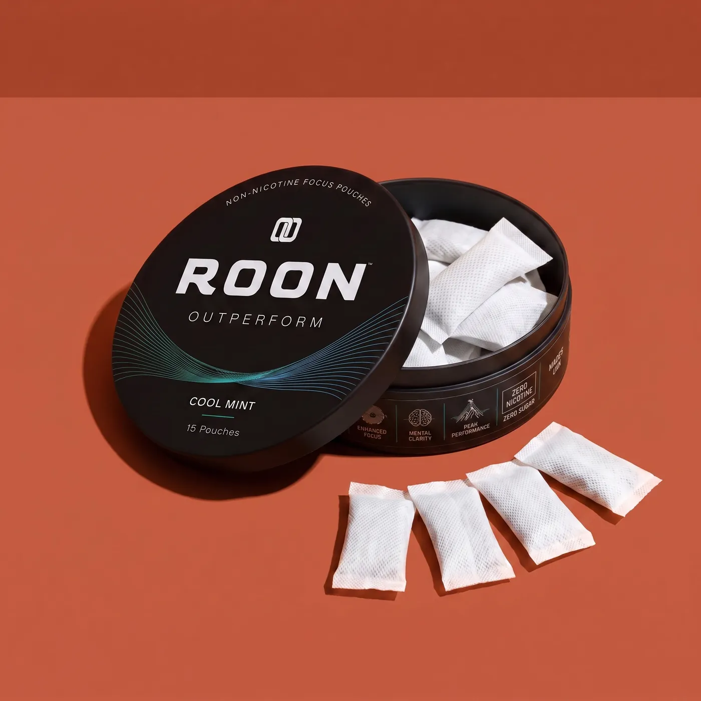 An open tin of Roon Cool Mint with four pouches fanned beside it, labelled with the caffeine, L-theanine, Dynamine and TeaCrine amounts per pouch.
