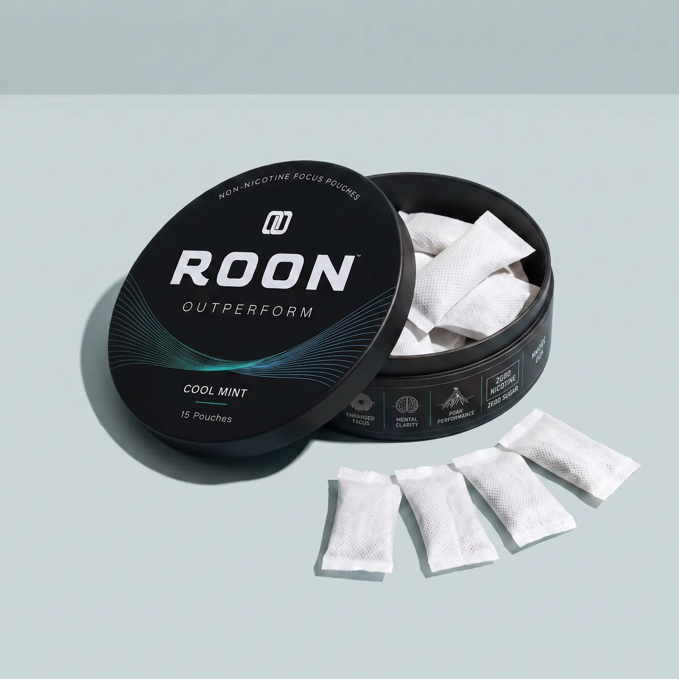 An open tin of Roon Cool Mint with four pouches fanned beside it, labelled with the caffeine, L-theanine, Dynamine and TeaCrine amounts per pouch.