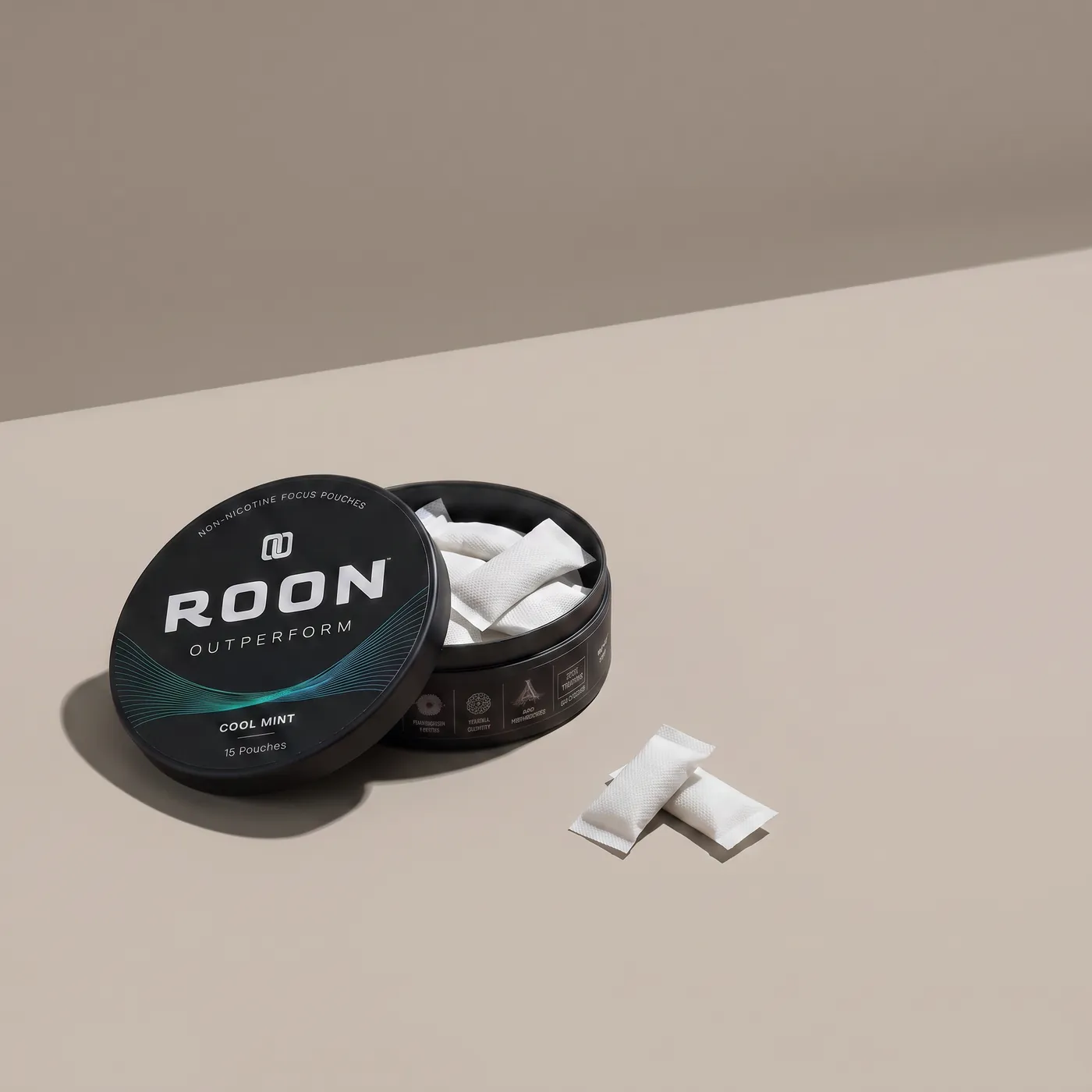 An open tin of Roon Cool Mint pouches on a bright desk beside a closed laptop and a notebook.