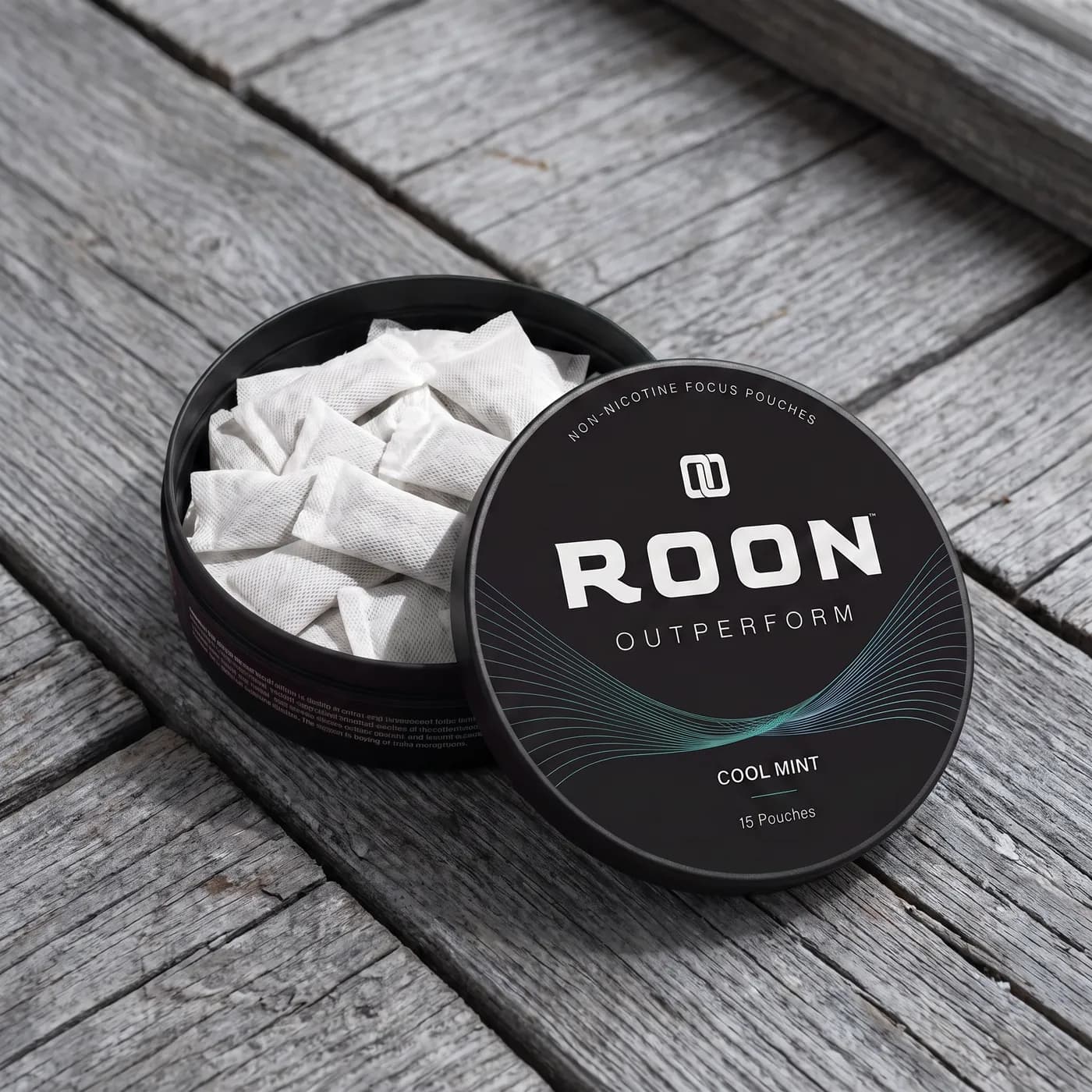 An open tin of Roon Cool Mint pouches on a windowsill in bright low-angle seasonal sunlight.