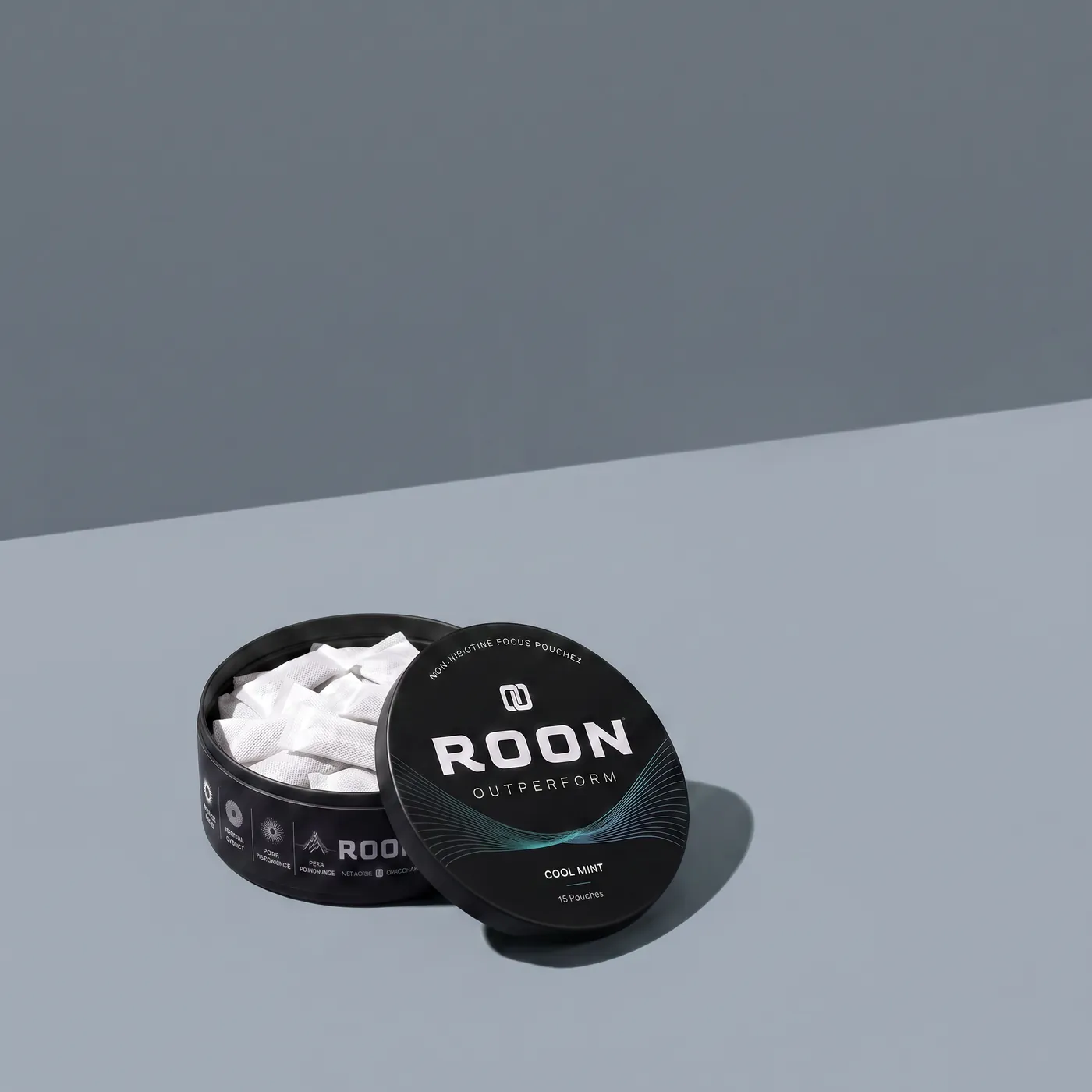 An open tin of Roon Cool Mint pouches on a bright break room counter beside a stainless flask.