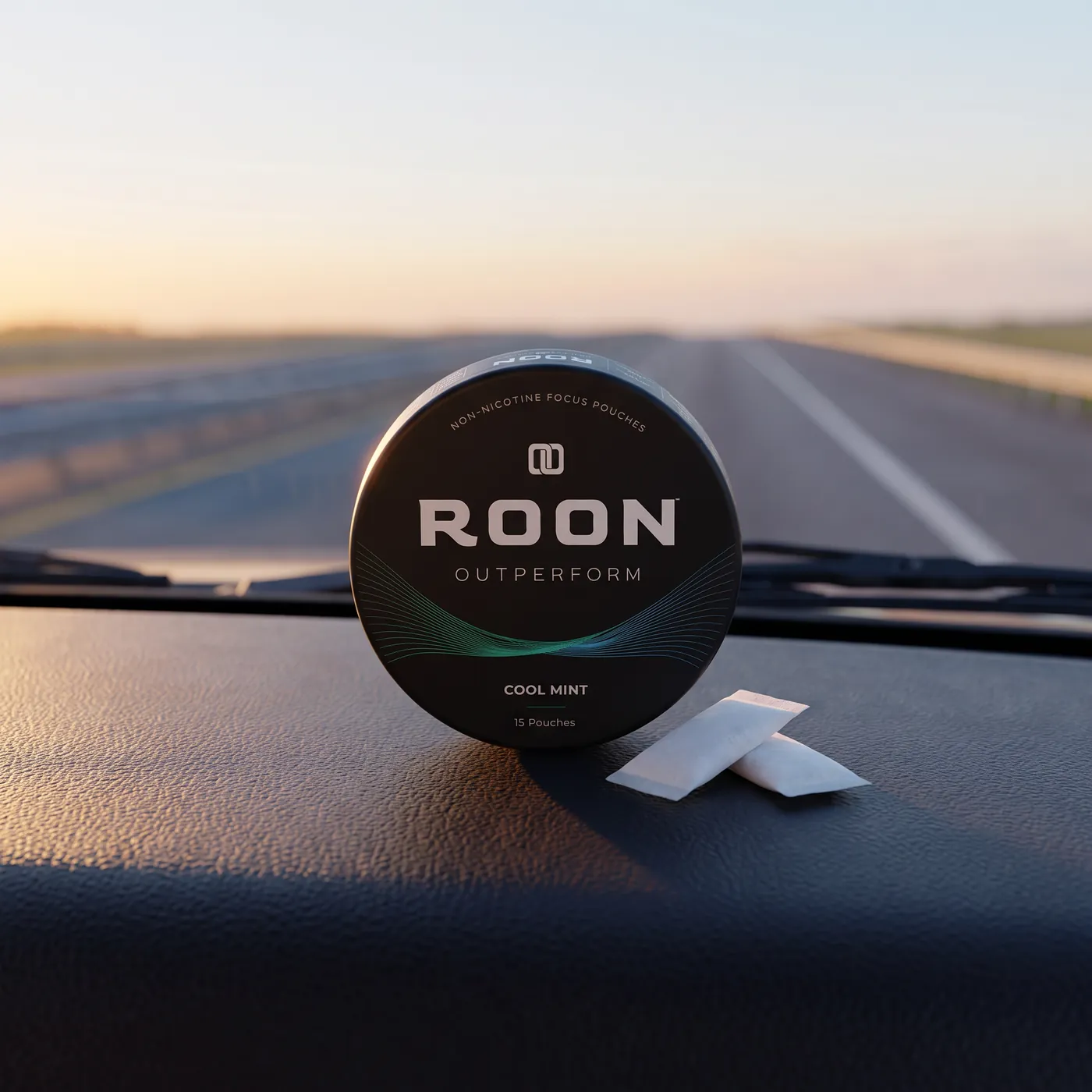 A closed tin of Roon Cool Mint pouches resting in a vehicle console cupholder in daylight.