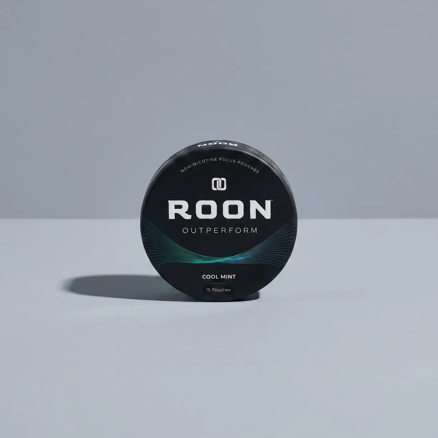 A closed tin of Roon Cool Mint pouches resting in a vehicle console cupholder in daylight.