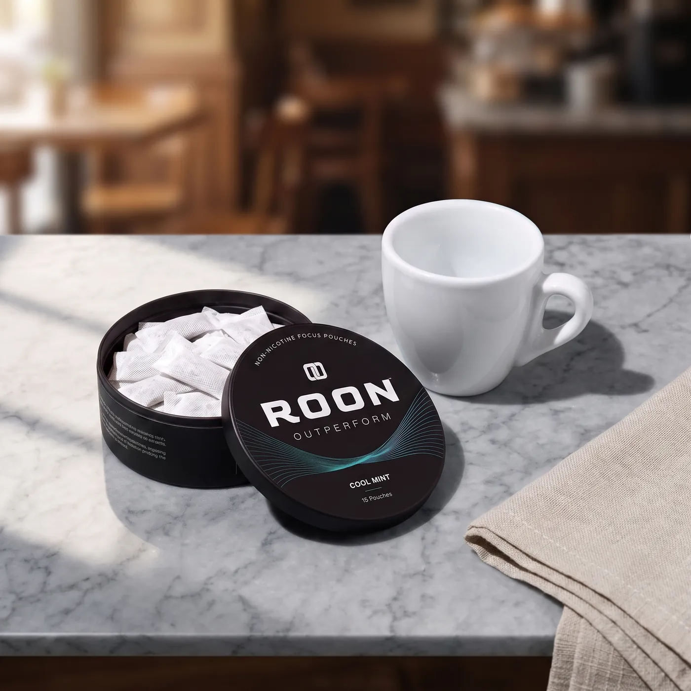 An open tin of Roon Cool Mint pouches beside an empty espresso cup, comparing a pouch to a cup of coffee.