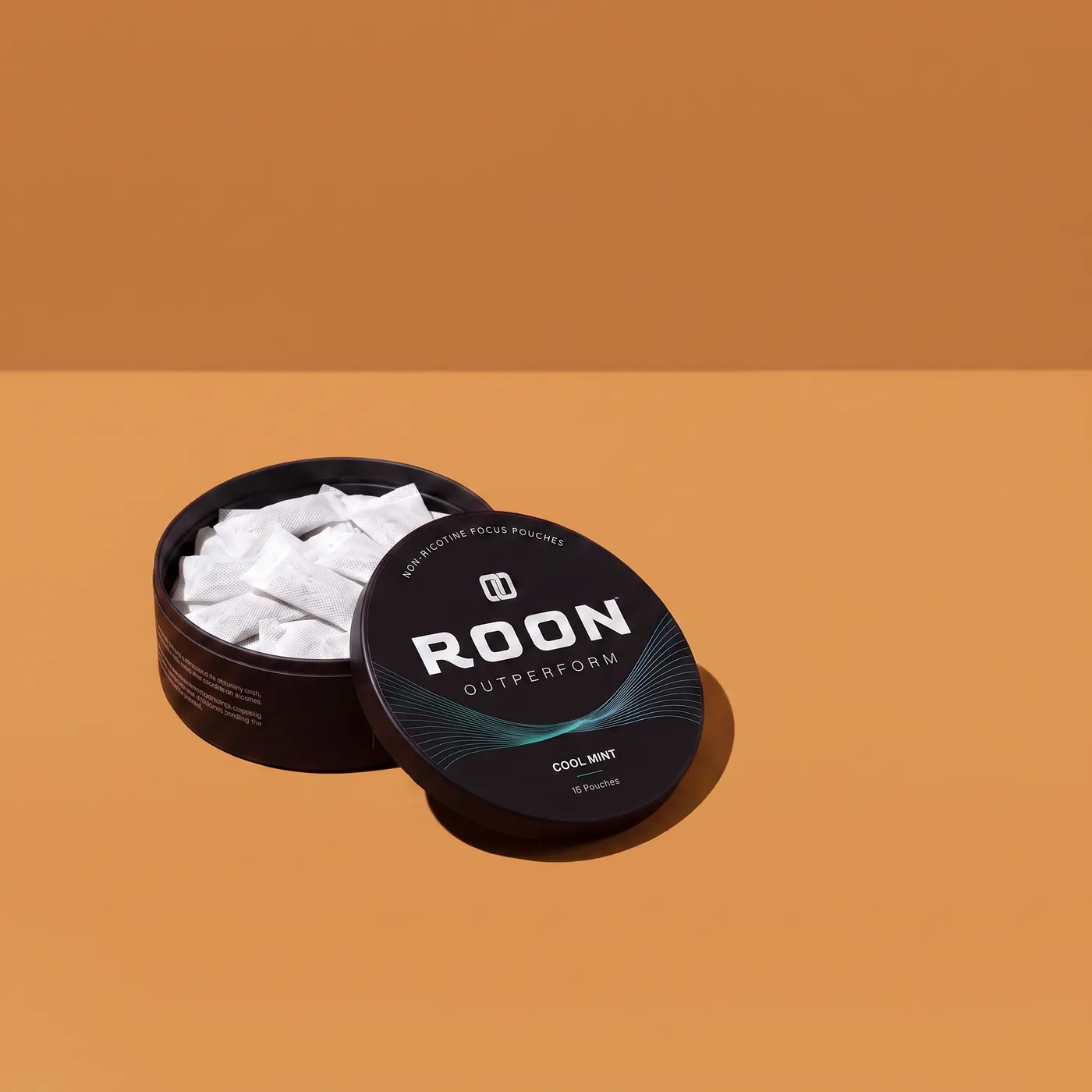 An open tin of Roon Cool Mint pouches beside an empty espresso cup, comparing a pouch to a cup of coffee.