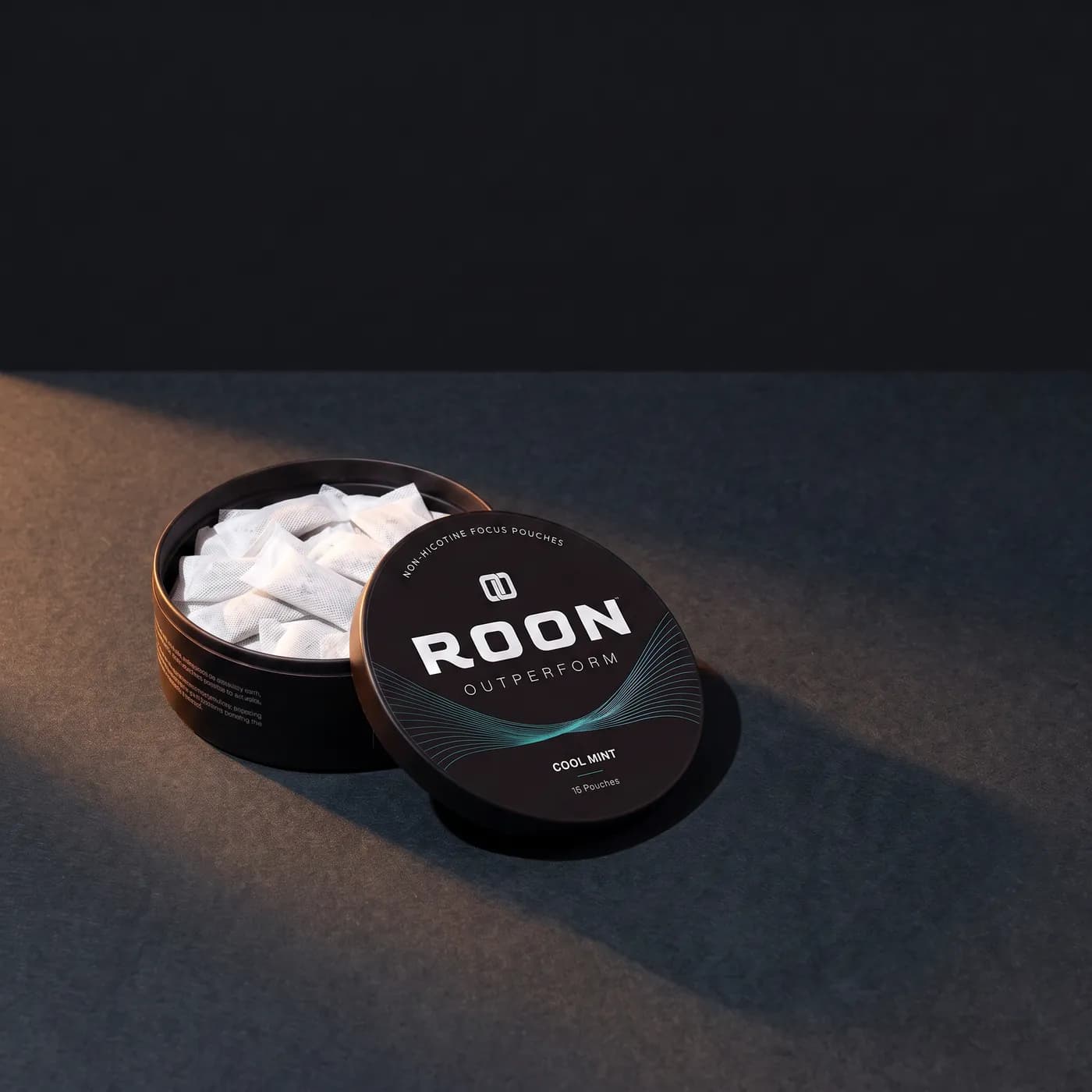 An open tin of Roon Cool Mint pouches beside an empty espresso cup, comparing a pouch to a cup of coffee.
