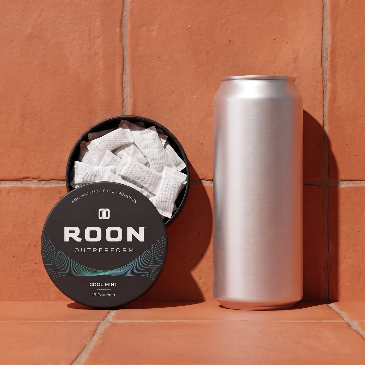 An open tin of Roon caffeine pouches in front of a plain slim energy drink can, comparing the two formats.