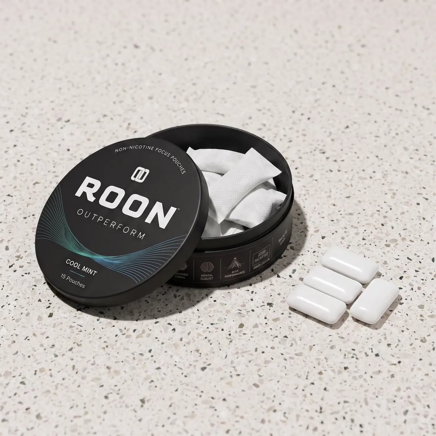 An open tin of Roon caffeine pouches next to pieces of caffeine gum, comparing the two formats.