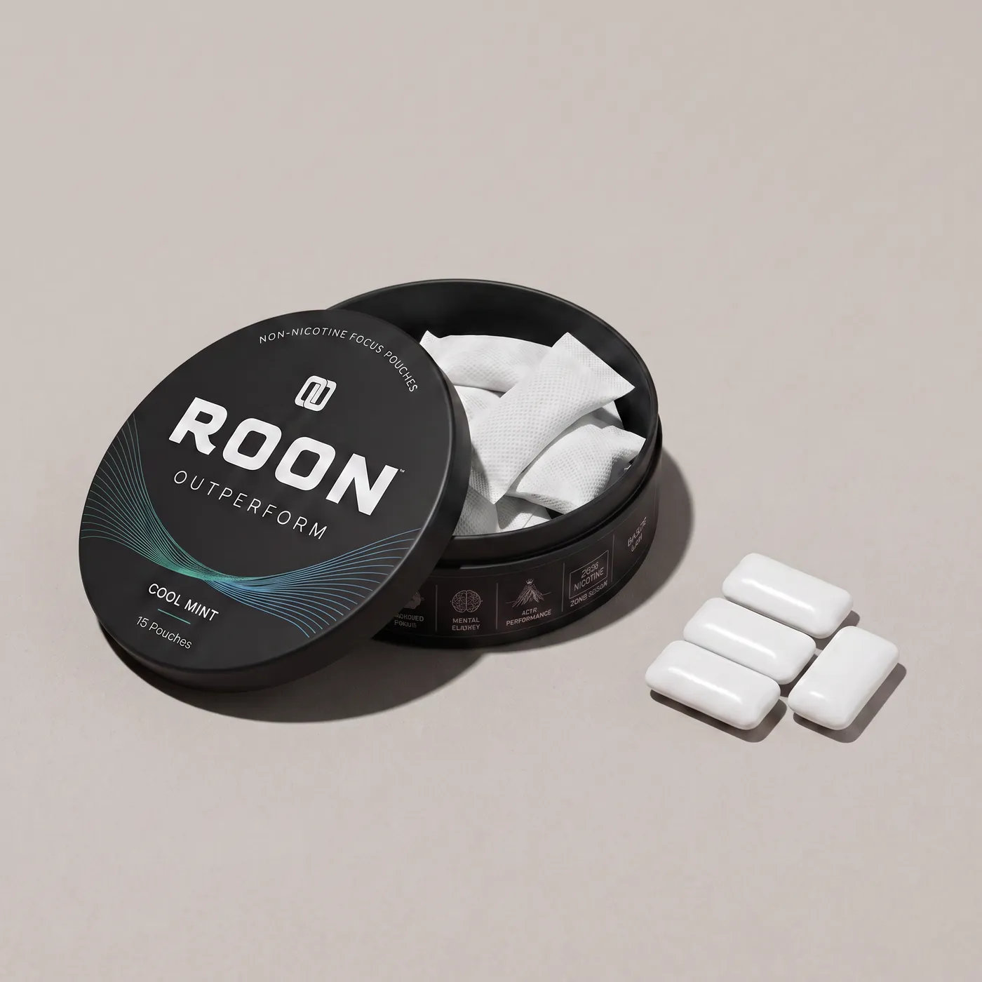 An open tin of Roon caffeine pouches next to pieces of caffeine gum, comparing the two formats.