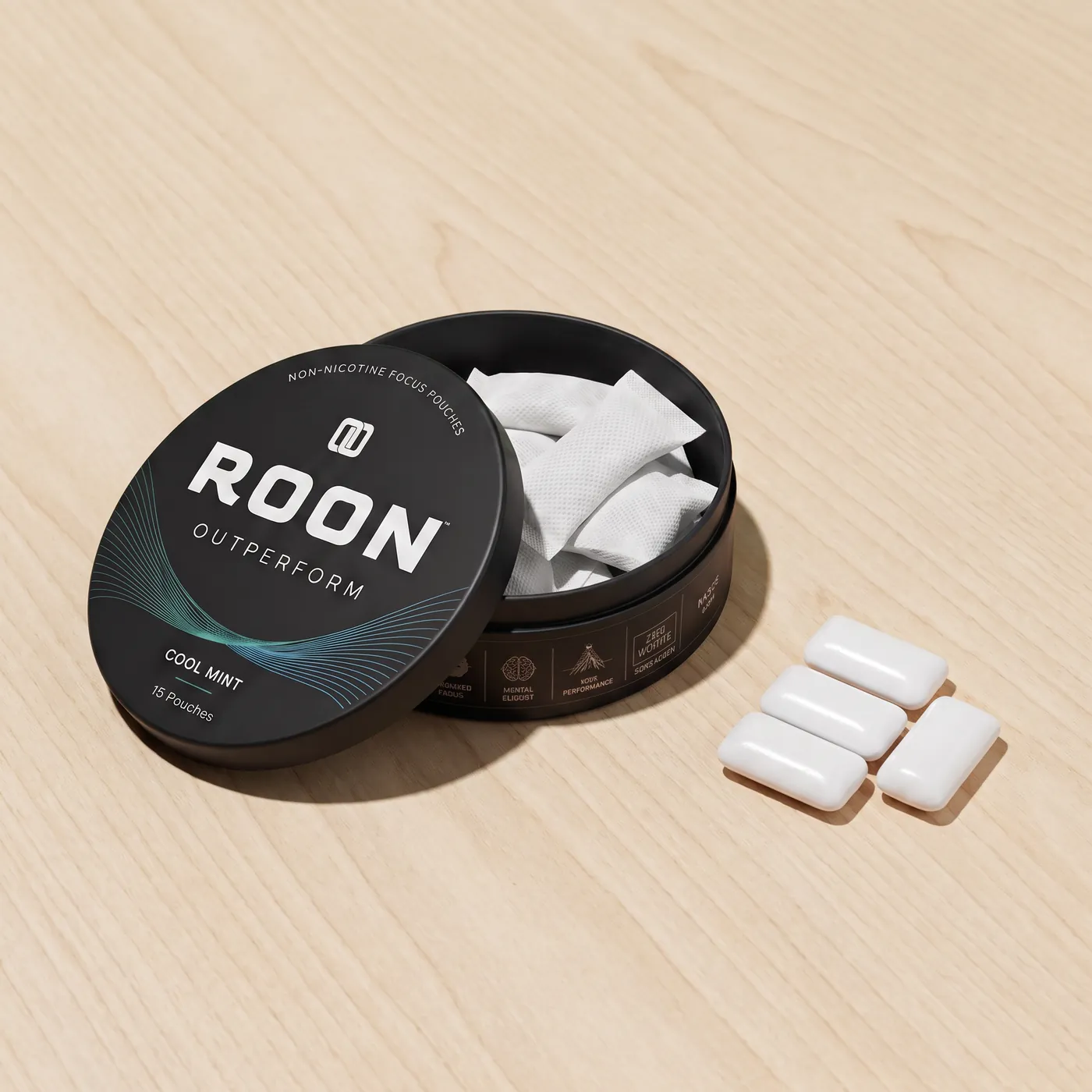 An open tin of Roon caffeine pouches next to pieces of caffeine gum, comparing the two formats.
