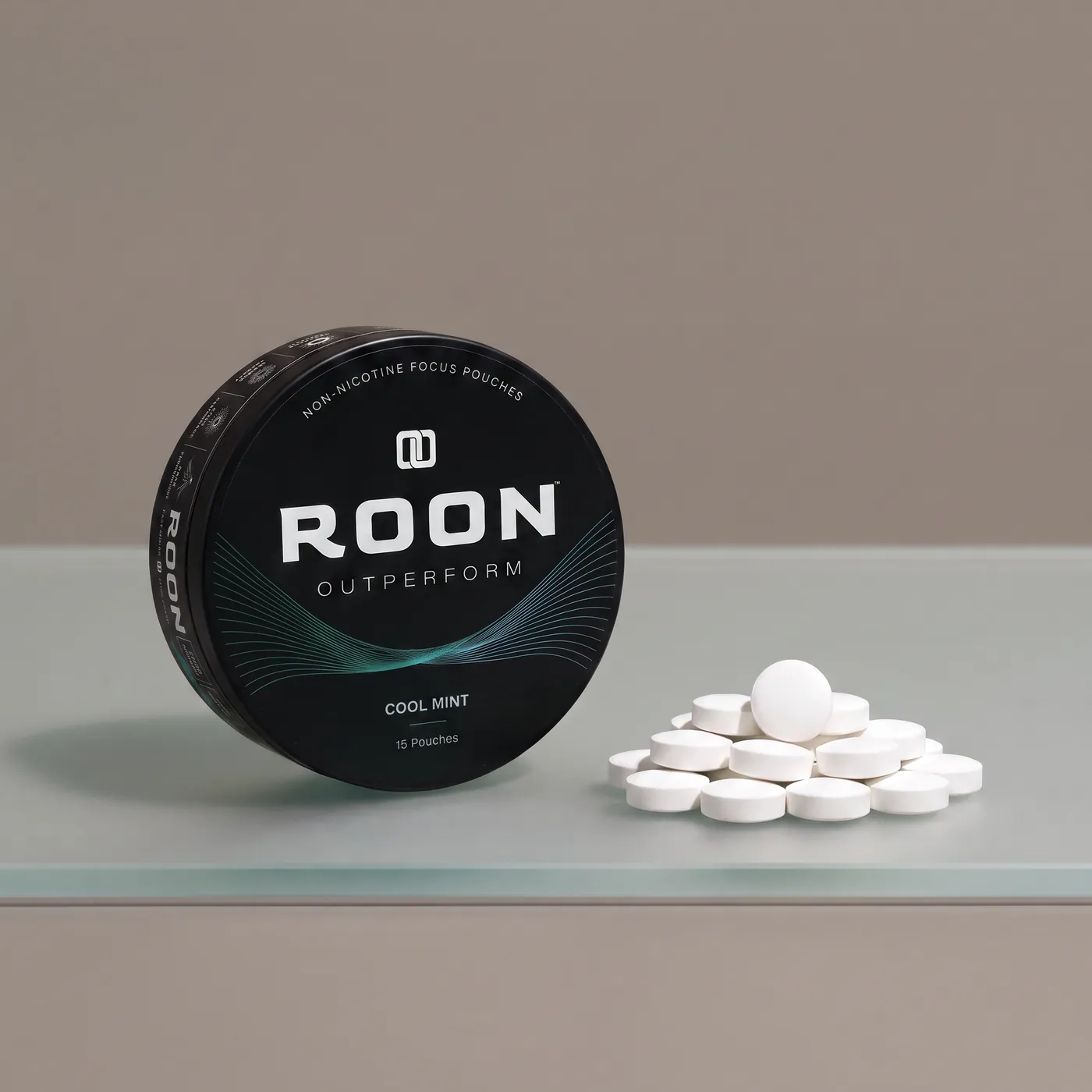 An open tin of Roon caffeine pouches next to loose caffeine tablets, comparing the two formats.
