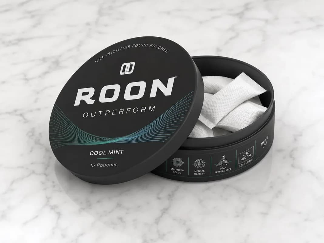 An open tin of Roon Cool Mint pouches on a marble counter